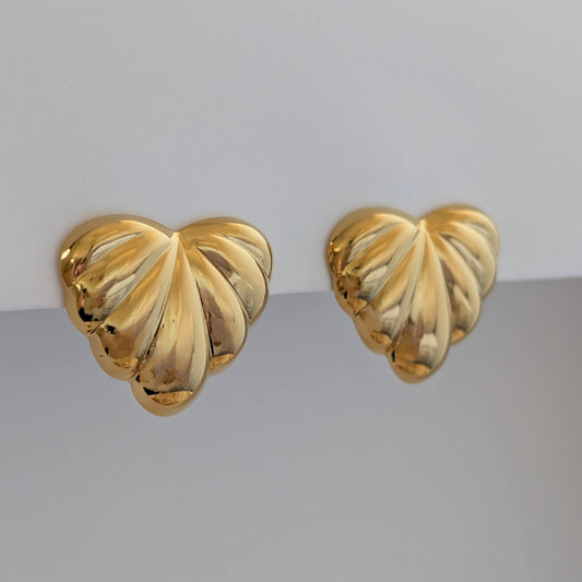 Side angle showing sculpted palm leaves and 2.6 × 3 cm size on gold statement earrings.
