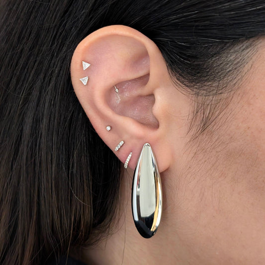 Lifestyle shot: Raya silver teardrop earrings worn—bold drop style, hypoallergenic and waterproof.