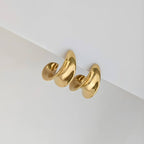 Gold Curved earring on a white background