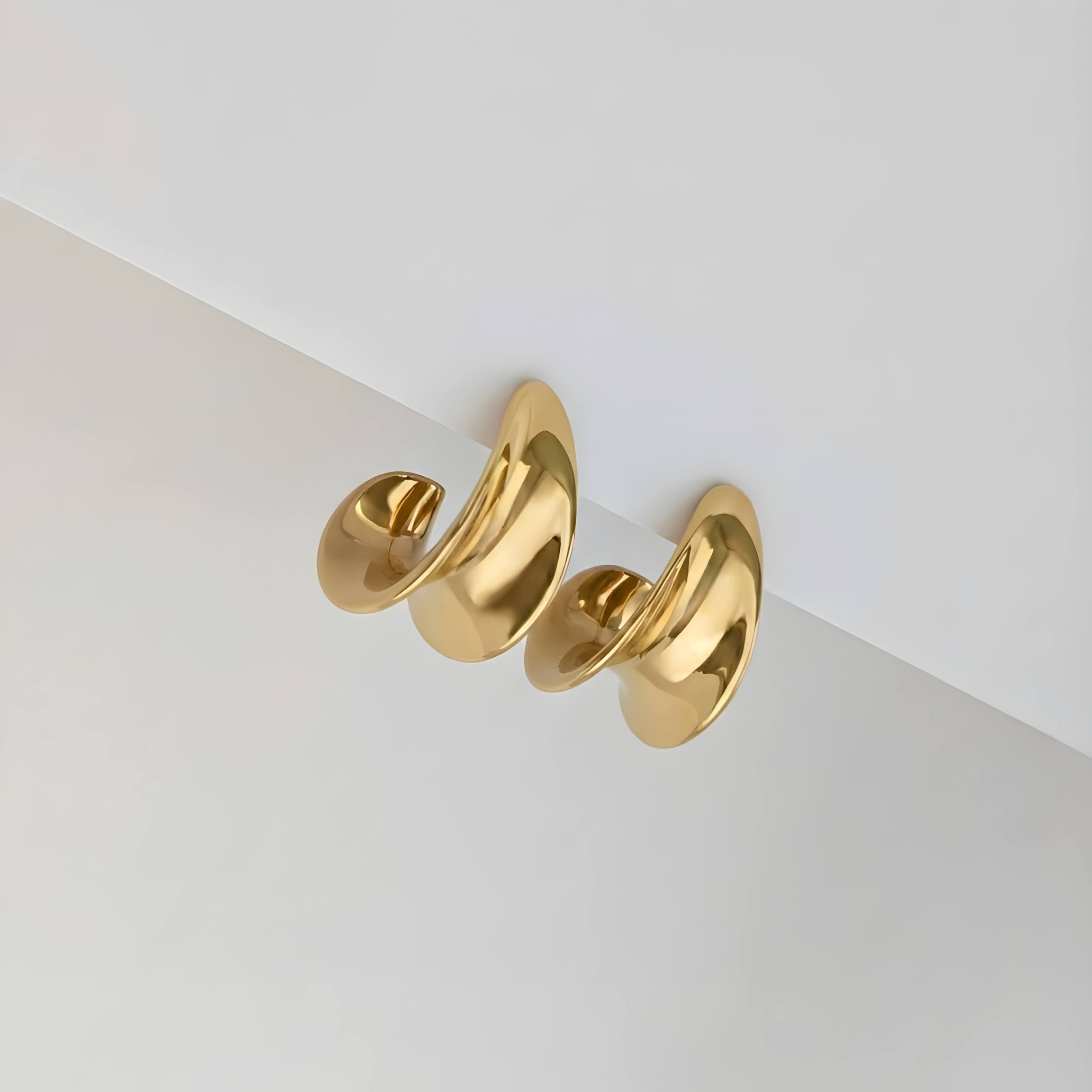 Gold Curved earring on a white background