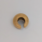 Gold ear cuff on a gray background