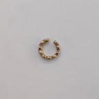 Gold Cuff earring on a light gray background