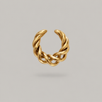 A gold twisted open ear cuff, no piercing ear wrap shown on a neutral light gray background.