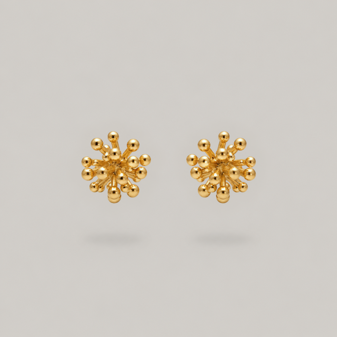 A pair of gold stud earrings with a textured, spherical cluster design resembling small metallic beads radiating from a central point, shown on a solid light gray background.