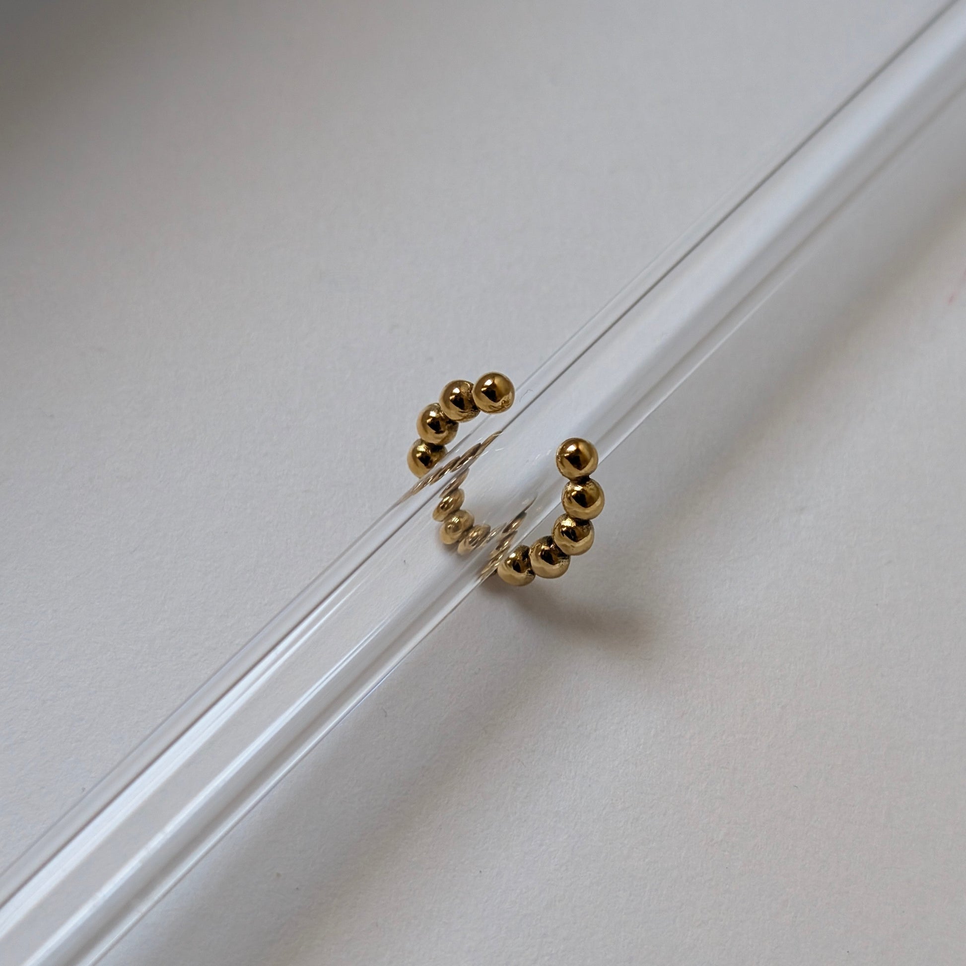 Gold beaded ear cuff beside ruler showing 1.54 cm diameter mini size reference.