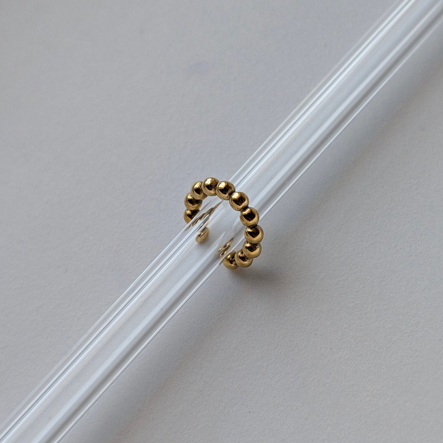 Gold beaded ear cuff beside ruler showing 1.54 cm diameter mini size reference.