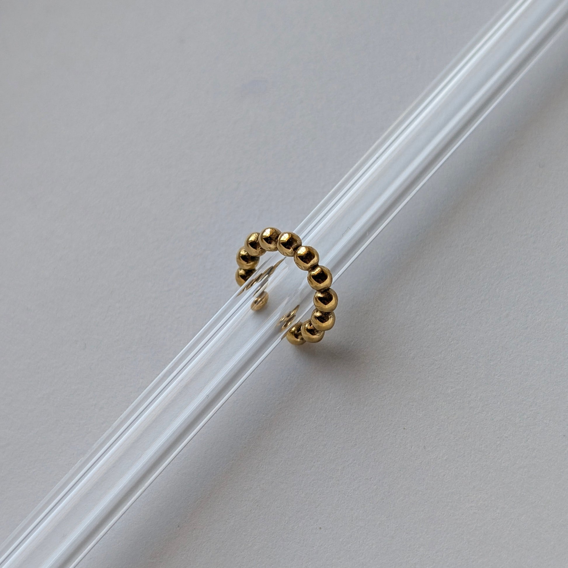Gold beaded ear cuff beside ruler showing 1.54 cm diameter mini size reference.
