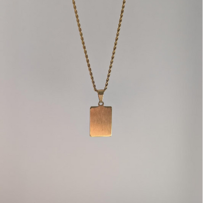 Alternate back angle of gold letter medallion pendant highlighting polished 18k plating and lobster clasp detail.