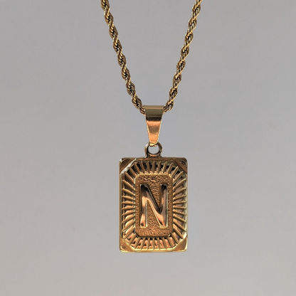 Front view of gold medallion letter necklace—18k plated initial pendant, 50 cm rope chain, 2.3 × 1.7 cm size.