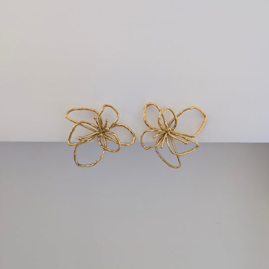 Alternate front angle highlighting textured orchid petals on gold statement earrings, lightweight 12.9 g pair