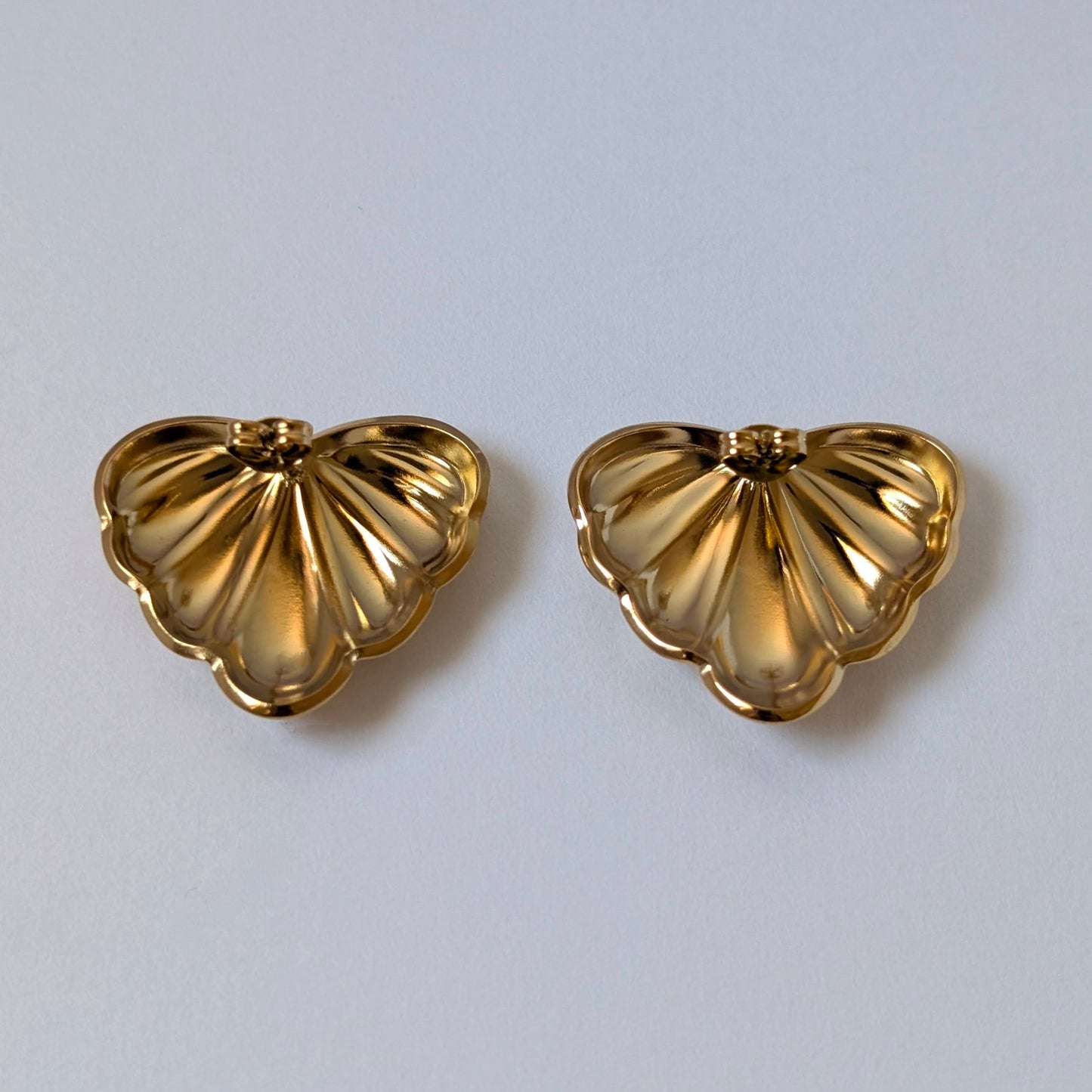 Back view with stainless‑steel post and butterfly clasp on gold palm leaf earrings.