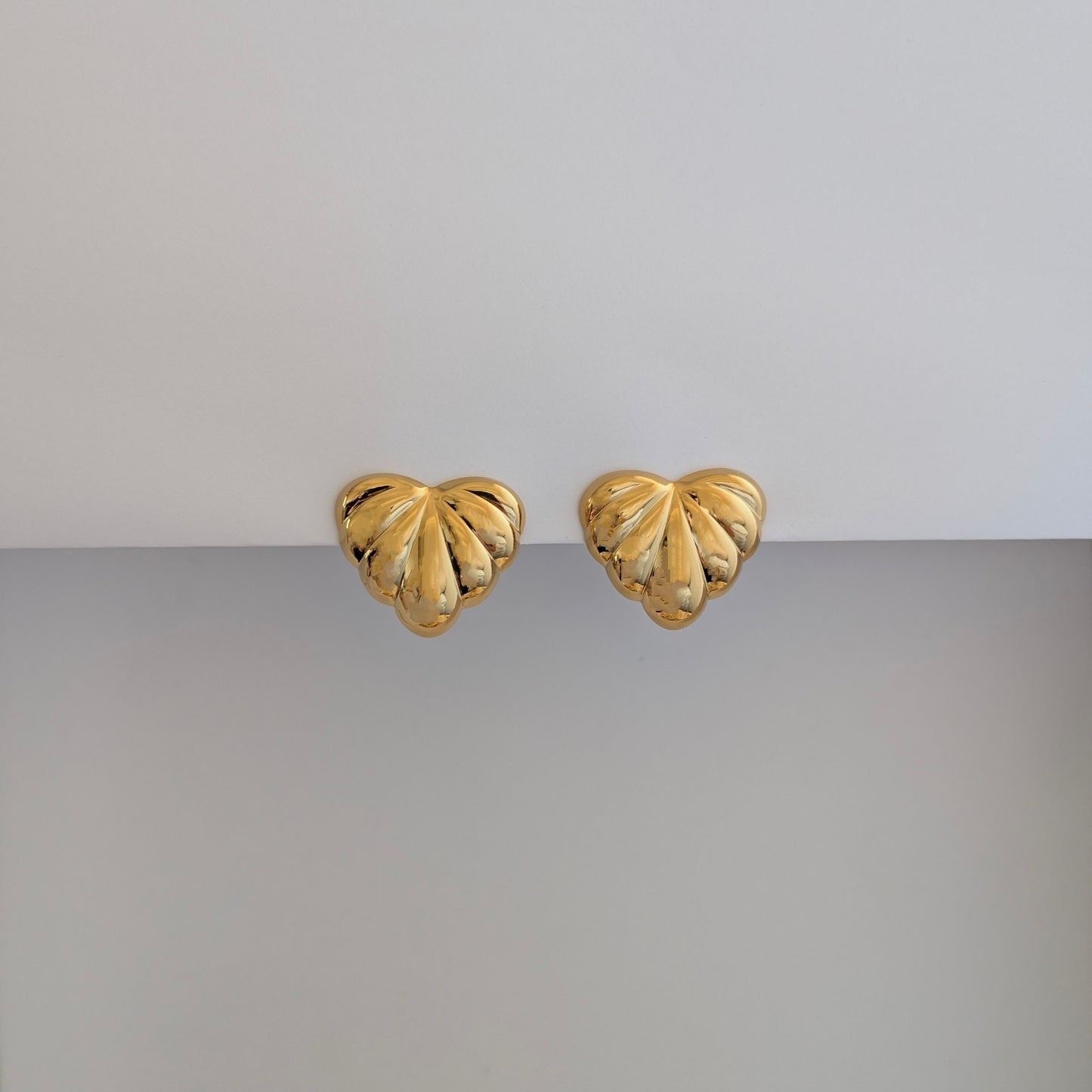 Front view of gold palm leaf statement earrings – 18k plated, high‑shine finish.