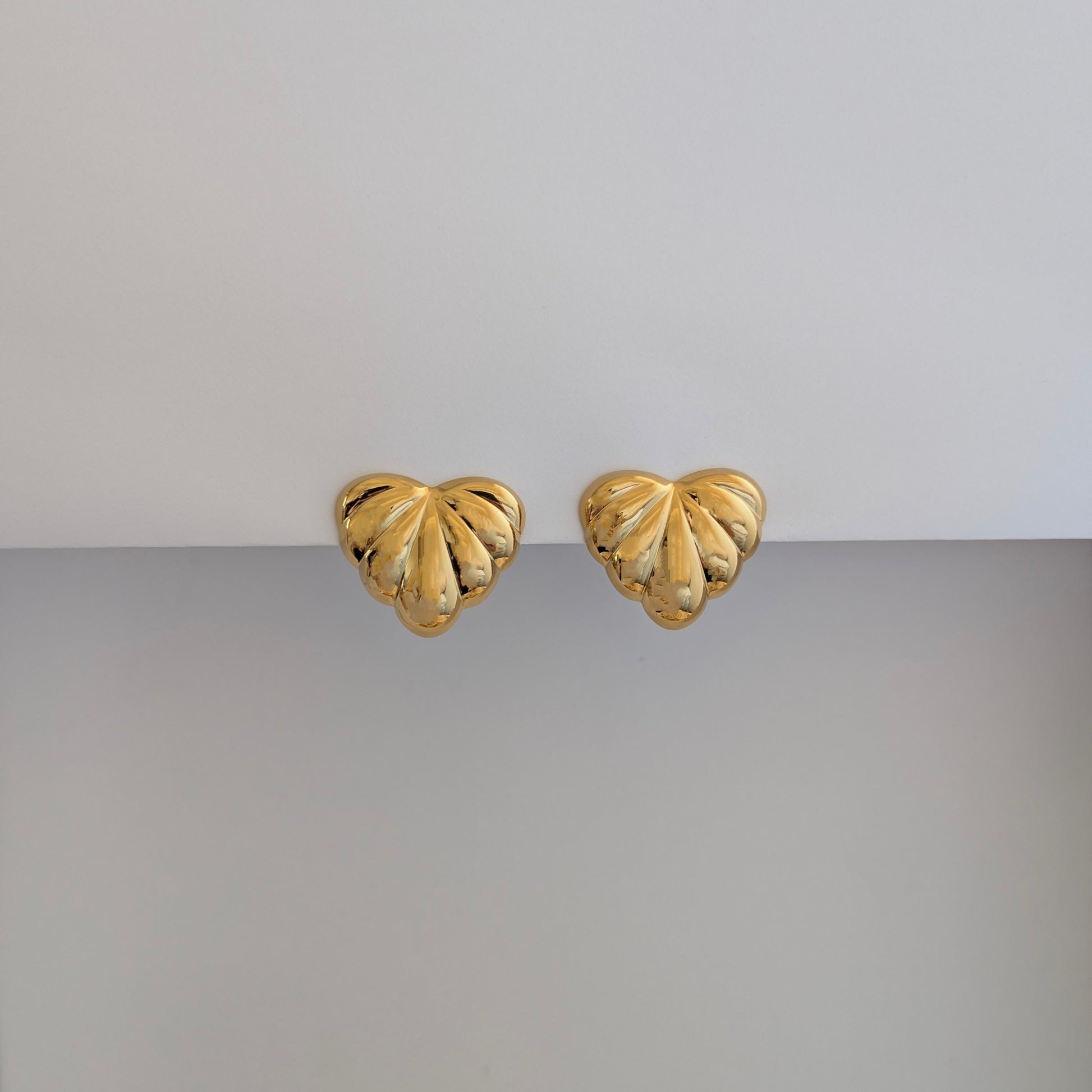 Front view of gold palm leaf statement earrings – 18k plated, high‑shine finish.