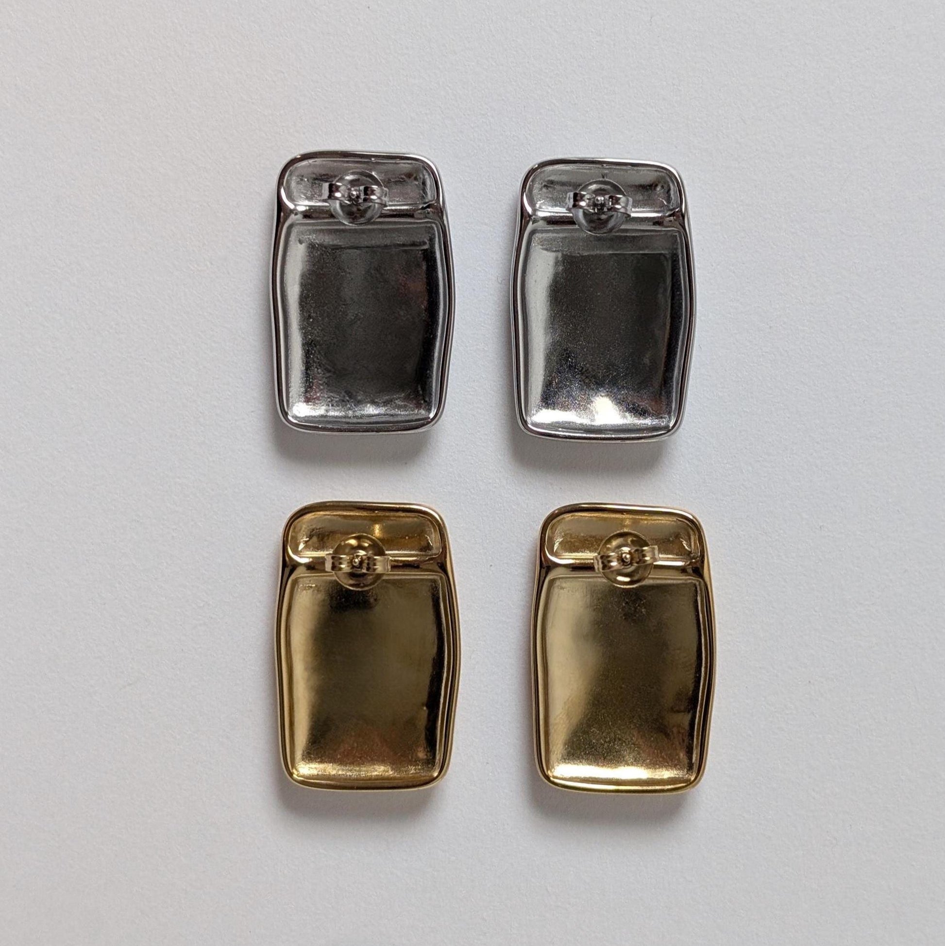 Back view of gold and silver chunky rectangle stud earrings—smooth reverse, stainless‑steel butterfly clasps.