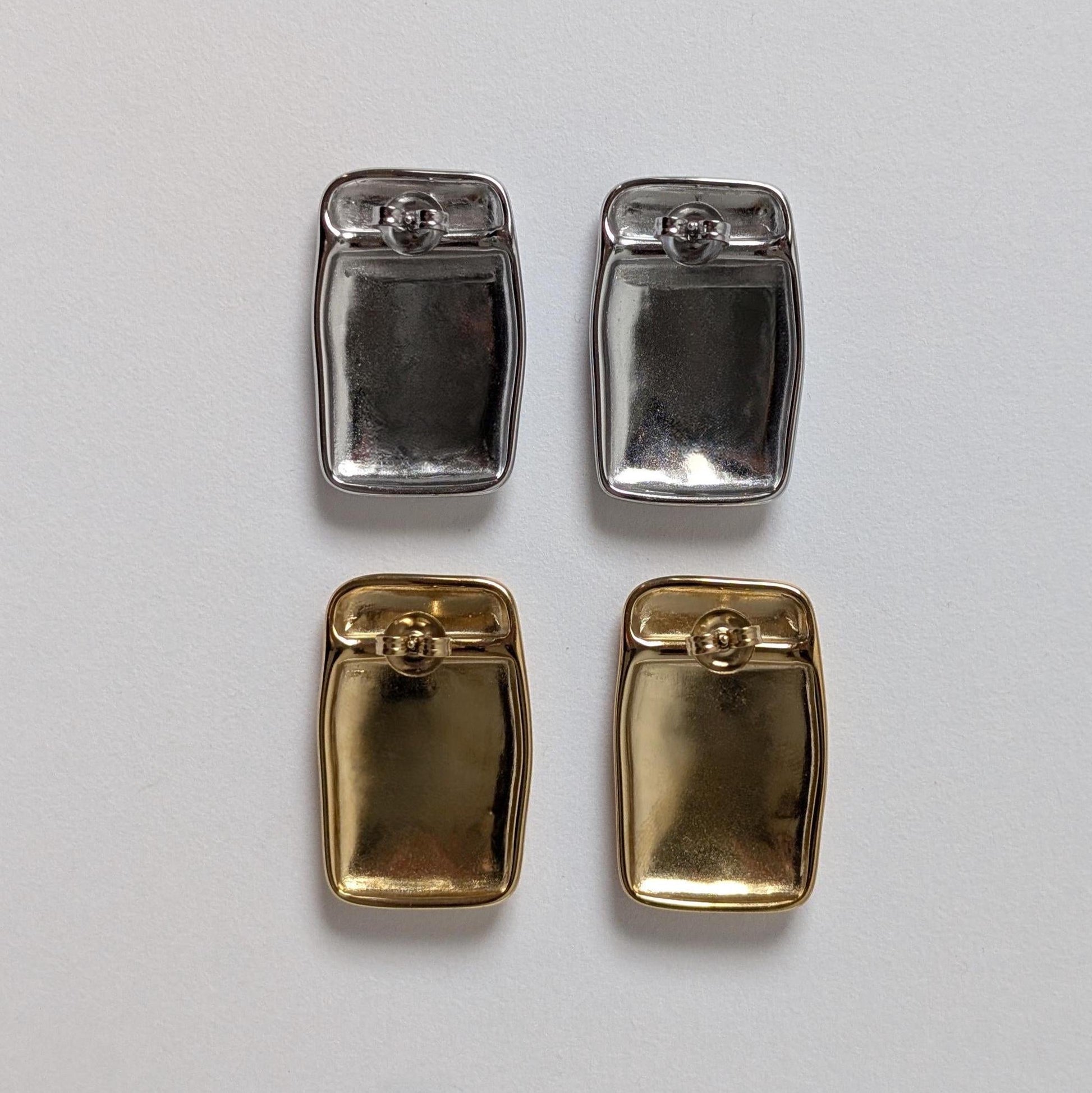 Back view of gold and silver chunky rectangle stud earrings—smooth reverse, stainless‑steel butterfly clasps.