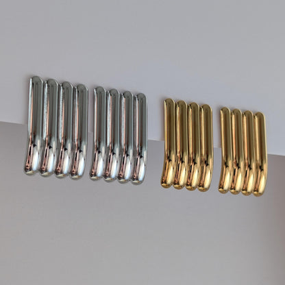 Side view of gold and silver sculptural stud earrings showing curved profile, 3.8 cm drop and hypoallergenic posts.