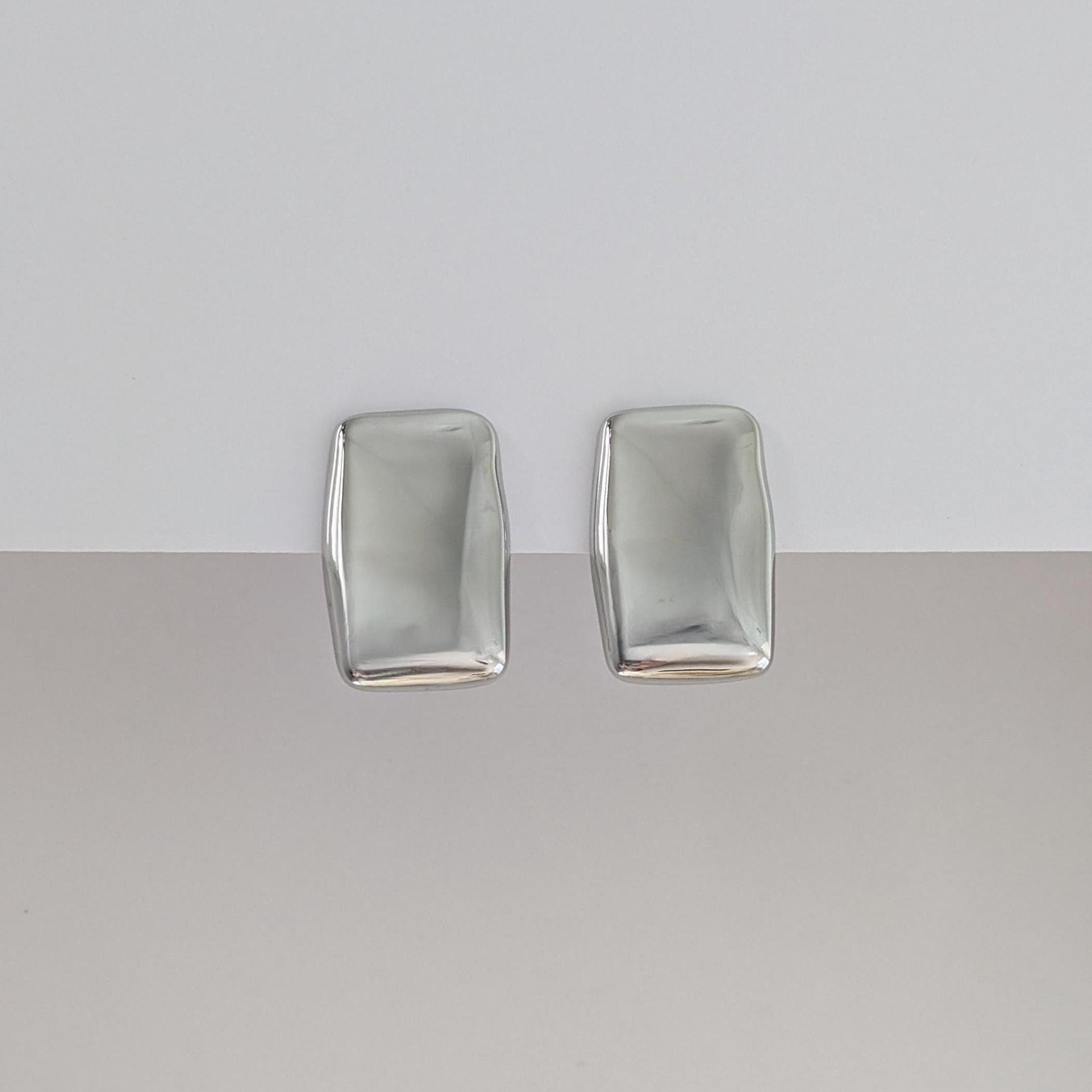 Front view of silver chunky rectangle stud earrings—polished stainless steel, 1.98 × 3.07 cm.
