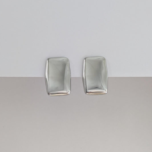 Front view of silver chunky rectangle stud earrings—polished stainless steel, 1.98 × 3.07 cm.