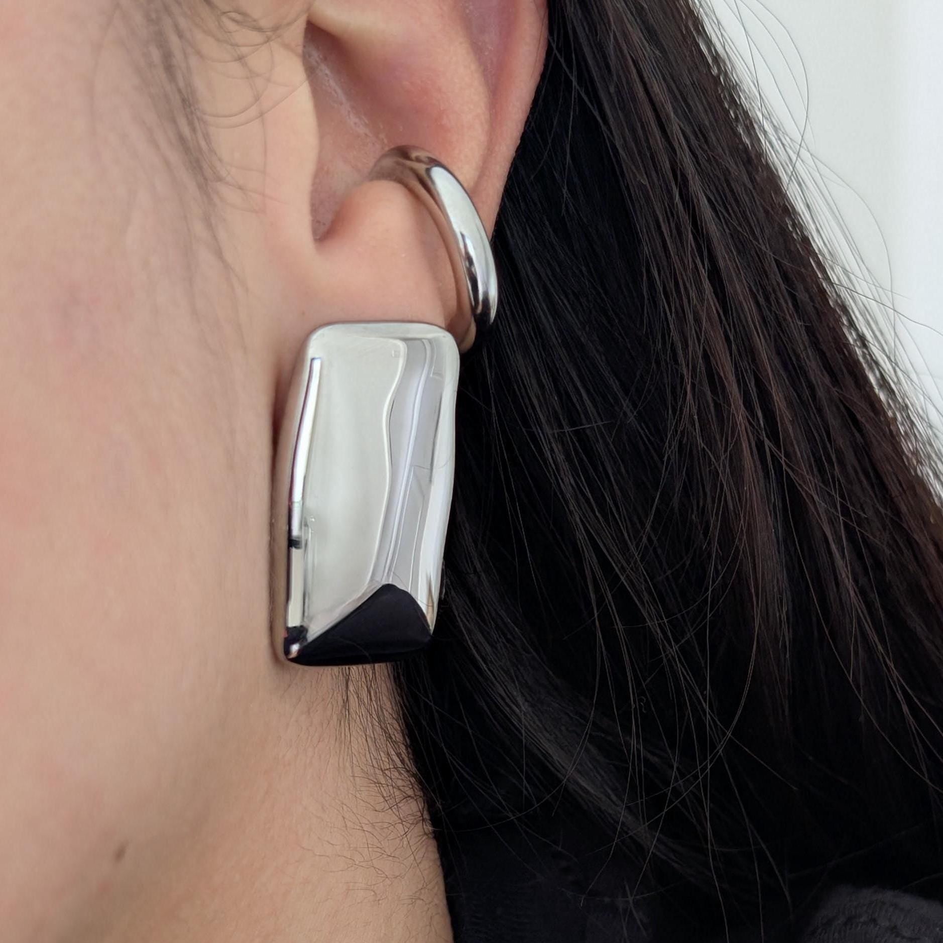 Lifestyle shot: silver chunky rectangle earrings worn, bold geometric statement.

