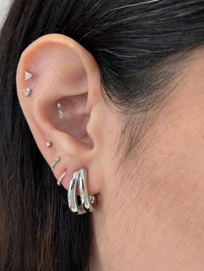 Side on‑ear angle highlighting sleek silver mini double hoops, waterproof and tarnish‑resistant for daily wear.