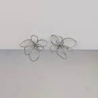 Front view of silver orchid statement earrings—polished stainless steel, sculptural petals, 4 × 4.21 cm studs.
