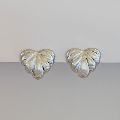 Front view of silver palm leaf statement earrings—316L steel base, hypoallergenic and tarnish resistant.