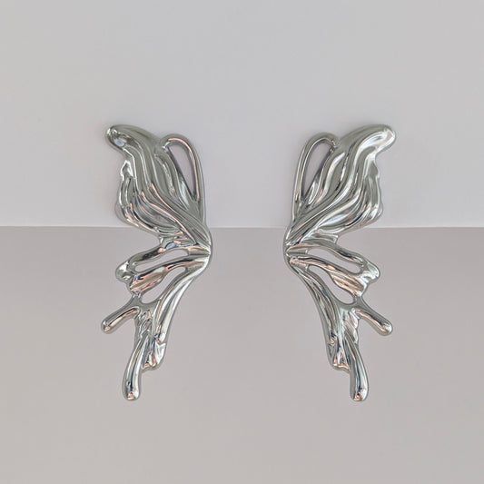 Alternate front angle showing curved silhouette of silver sculptural statement earrings, lightweight 9.3 g pair. 